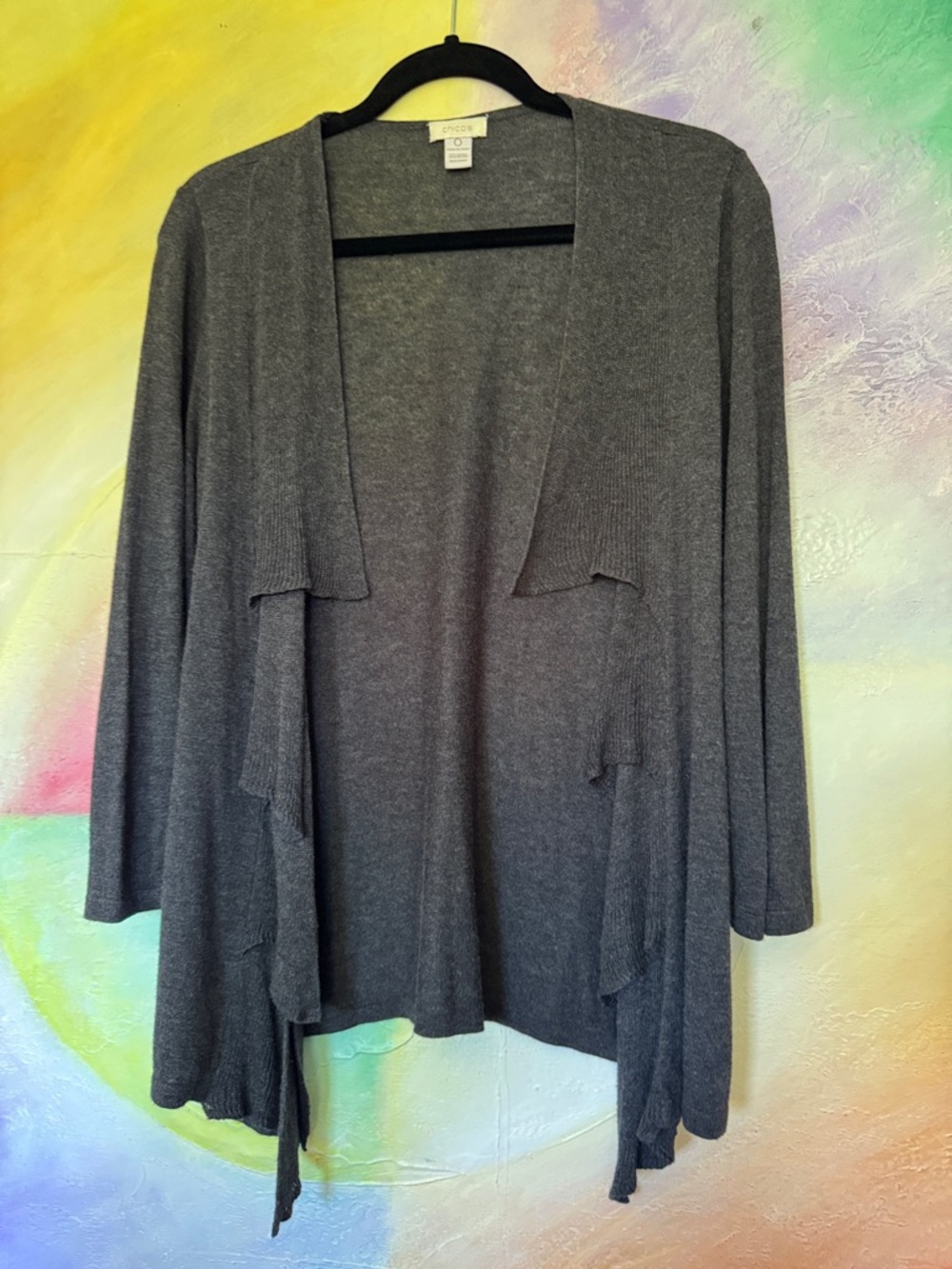 This charcoal gray draped-front cardigan is a piece from Chico’s, Size 0 (S)